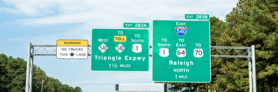 Two highway directional signs including exit 283A to Triangle Expressway Toll 540 and exit 283B Raleigh North East 540.