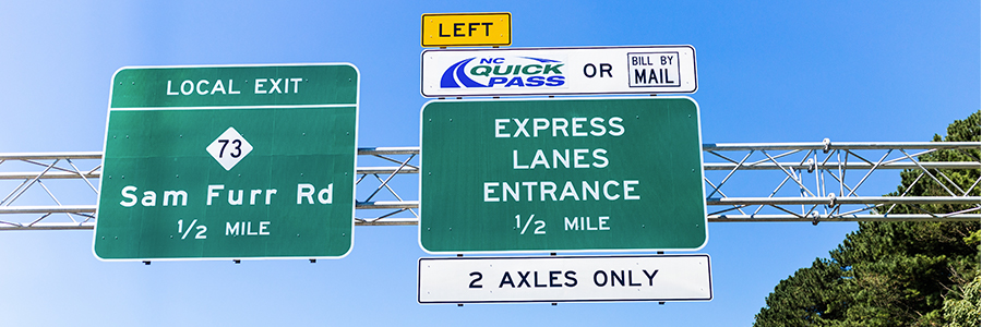 Two highway directional signs including Sam Furr Rd 73 Local Exit and Express Lanes Entrance 2 for I-77 Express Lanes